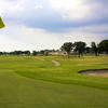 A view of green with clubhouse in background at Oakmont Country Club