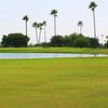 A view of a green with water fountain in foreground at Howling Trails Golf Course.