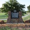A view of the entrance sign and a hole at Brownwood Country Club.