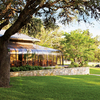 A view of the clubhouse with the putting green on the right at Fair Oaks Ranch Golf & Country Club